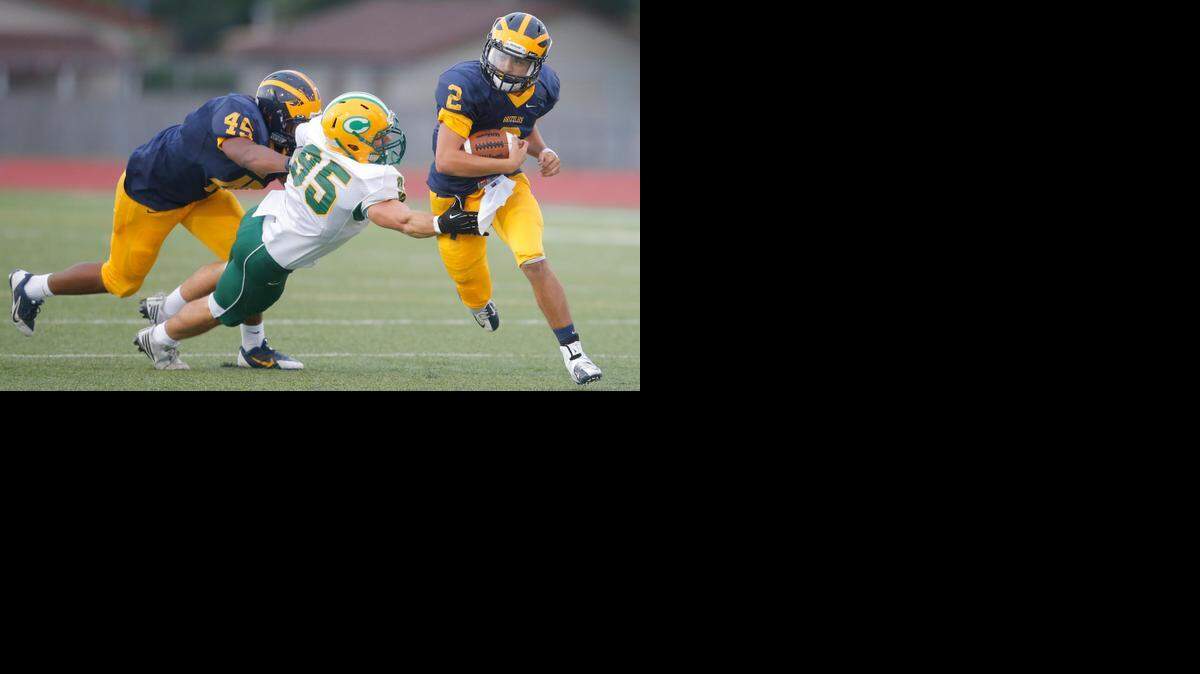 
Bishop Carroll's Jacob Morgan tries to stop Northwest ball carrier Kevin Folsom on Friday, Sept. 5.
