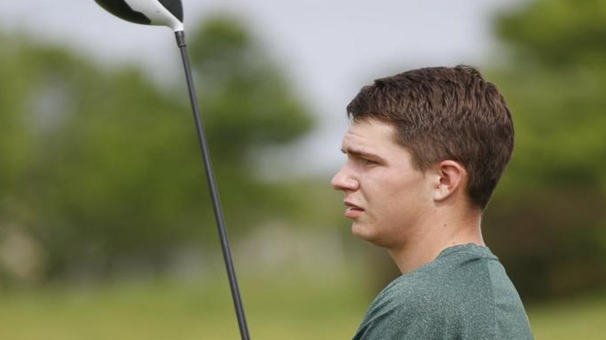 Carroll senior golfer Luke Brugman practicing on the driving range at Auburn Hills Golf Course.