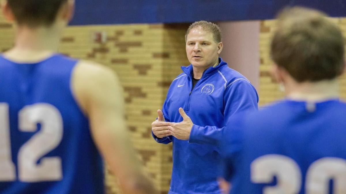 Kapaun boys basketball coach John Cherne runs through a upcoming opponent’s weaknesses and strengths with his team.