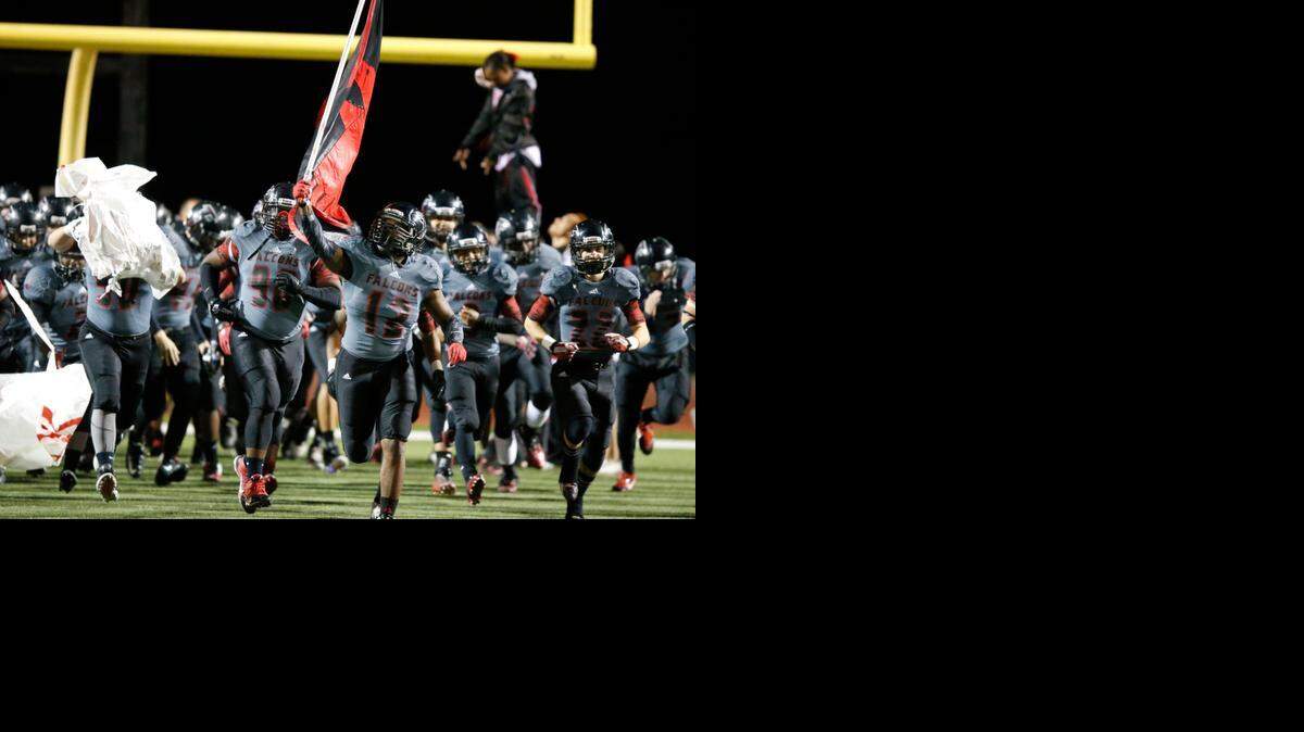 
Wichita Heights’ Trayon Haynes brings his team on to the field against Salina Central on Nov. 7.
