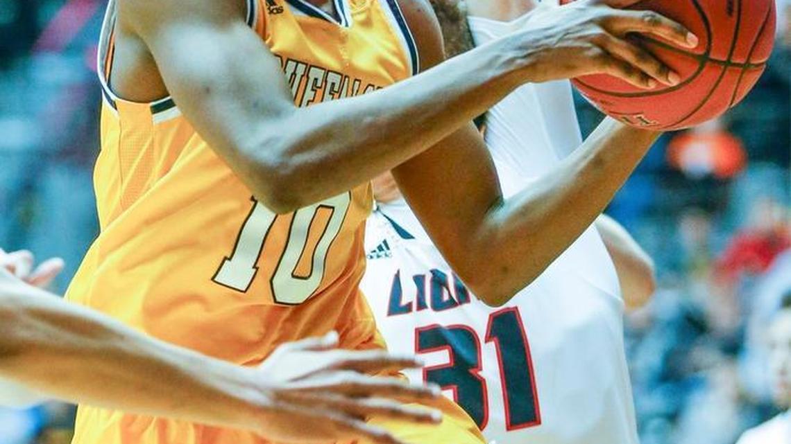 Southeast's Jerrick Harding dishes the ball off during their 6A semifinal game against Lawrence at Koch Arena on March 11. Harding, a three-time City League scoring champion, committed to Weber State on Friday.