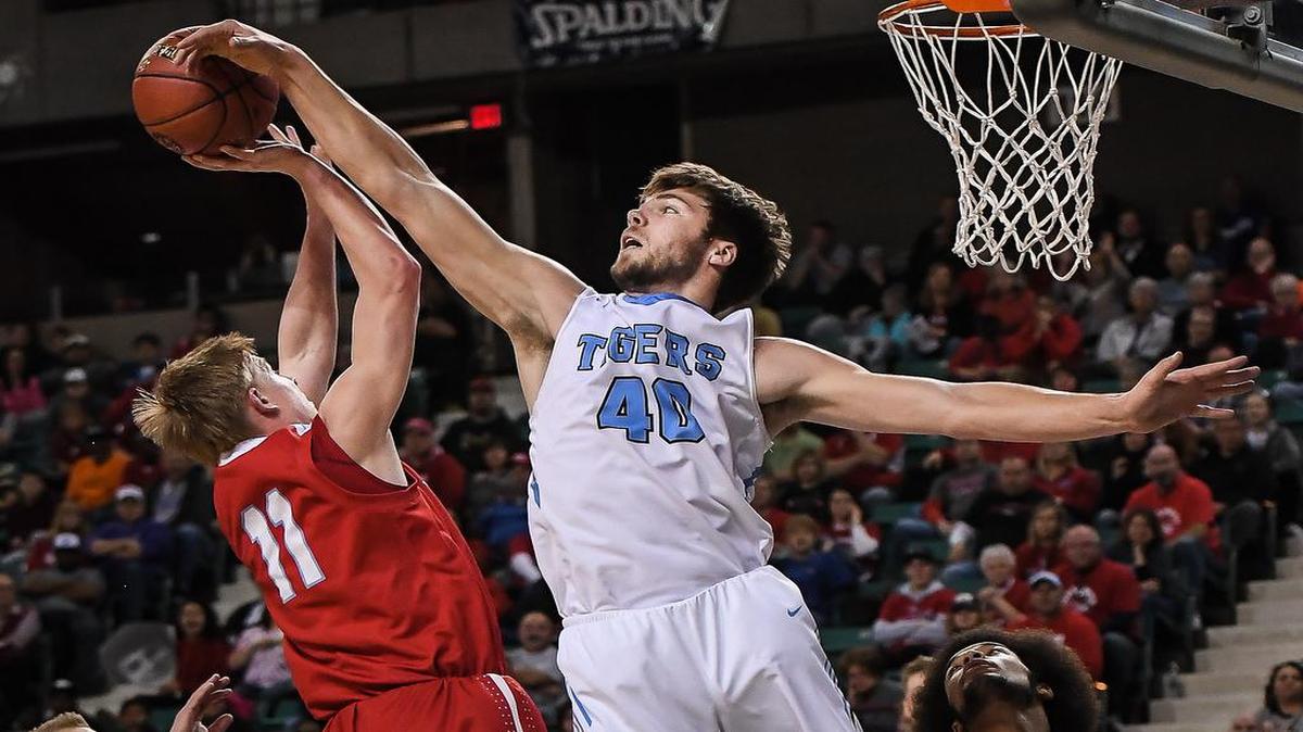 Eisenhower’s Matt Pile, right, blocks a shot by Shawnee Heights’ Tyler Zenter.