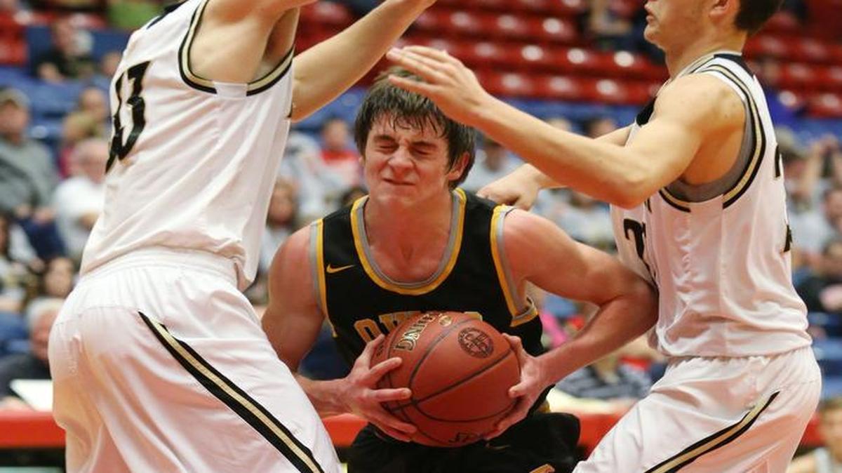 Garden Plain’s Nathan Pauly drives to the basket between Fredonia’s Jared Reed and Justin Solander in the second quarter during the 3A boys state tournament on Wednesday at the Sports Arena.