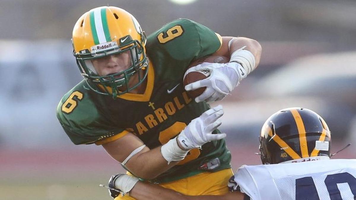 Carroll's Adam Theis breaks the arm tackle of a Northwest defender last season. “He may be small, but he sees the field better than anyone I’ve ever played with,” teammate Sam Nance said.