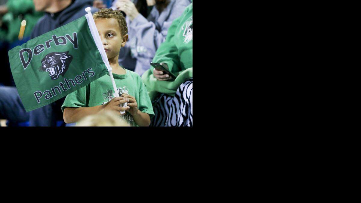 
Zindale Richards, 7, waves his flag before Derby’s game with Wichita East on Friday. 
