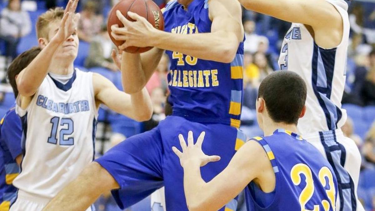 Collegiate’s Jacob Newlin, center, rebounds against Clearwater’s Kincaid Liebenberg (12) and Austin Smith, right, in the second quarter at Clearwater on Friday night.