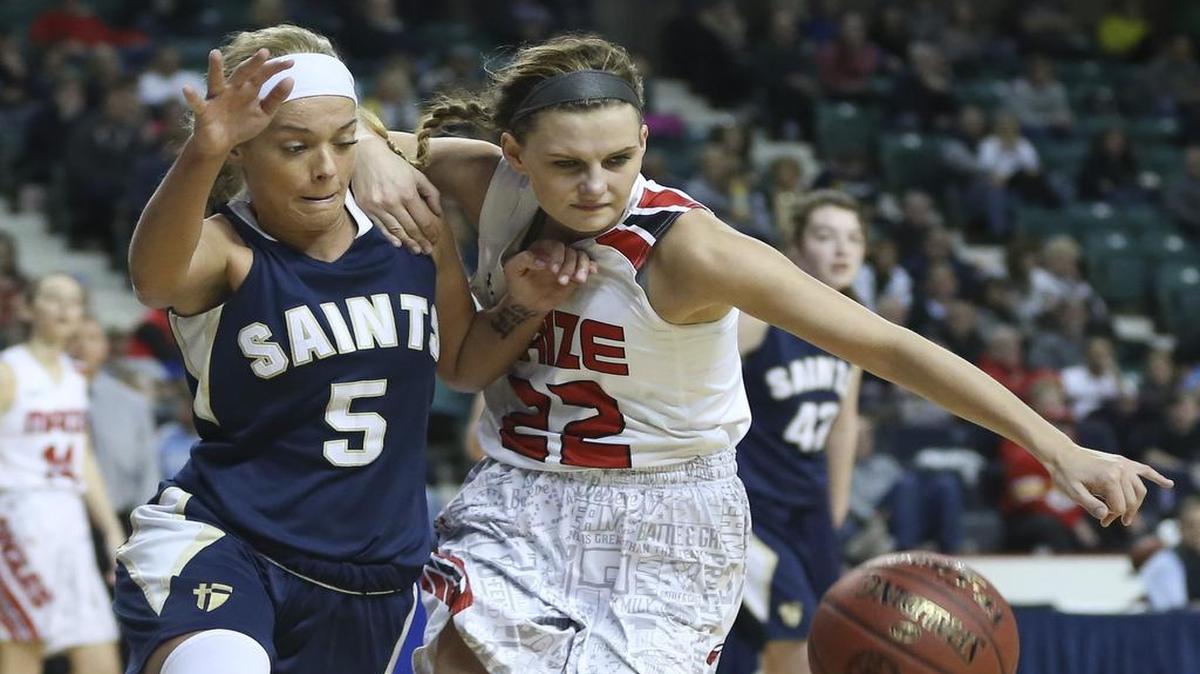 Maize’s Taylor Holmes fights with St. Thomas Aquinas’ Nicole Corrigan for a loose ball during the championship game of the 5A state tournament Saturday in Topeka.