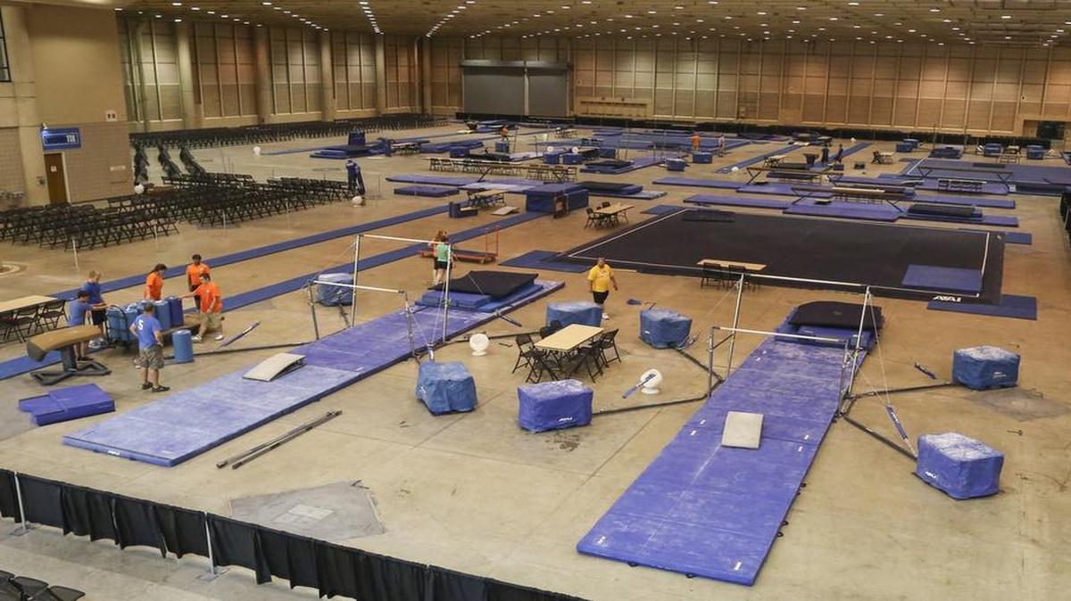 
Volunteers set up gymnastics equipment at Century II ahead of this weekend's YMCA National Gymnastics Championships. 
