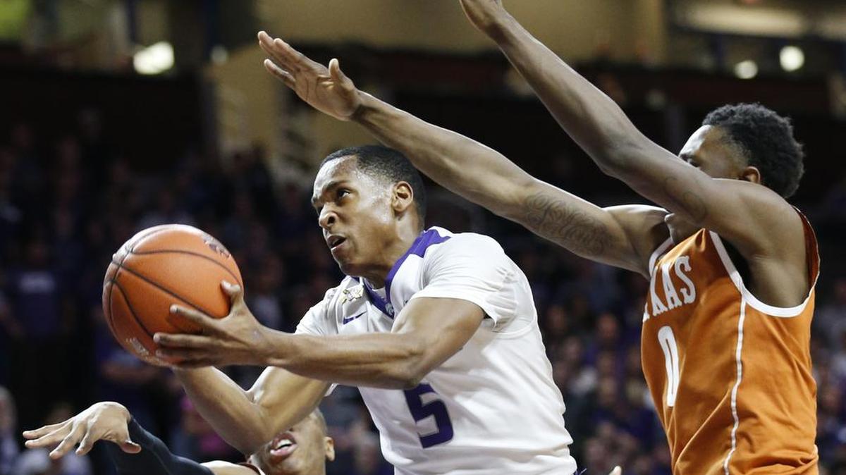 K-State guard Barry Brown (5) is pressured by Texas guard Tevin Mack (0) as he drives for the basket Monday night in Bramlage Coliseum.(February 22, 2016)