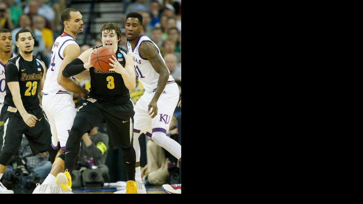
Wichita State guard Evan Wessel passes the ball after grabbing an offensive rebound against Kansas in the NCAA Tournament at CenturyLink Center in Omaha. 
