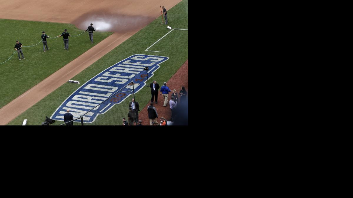 
The grounds crew waters down the area near first base before Game 4 of the World Series between the Royals and Giants on Saturday in San Francisco. 
