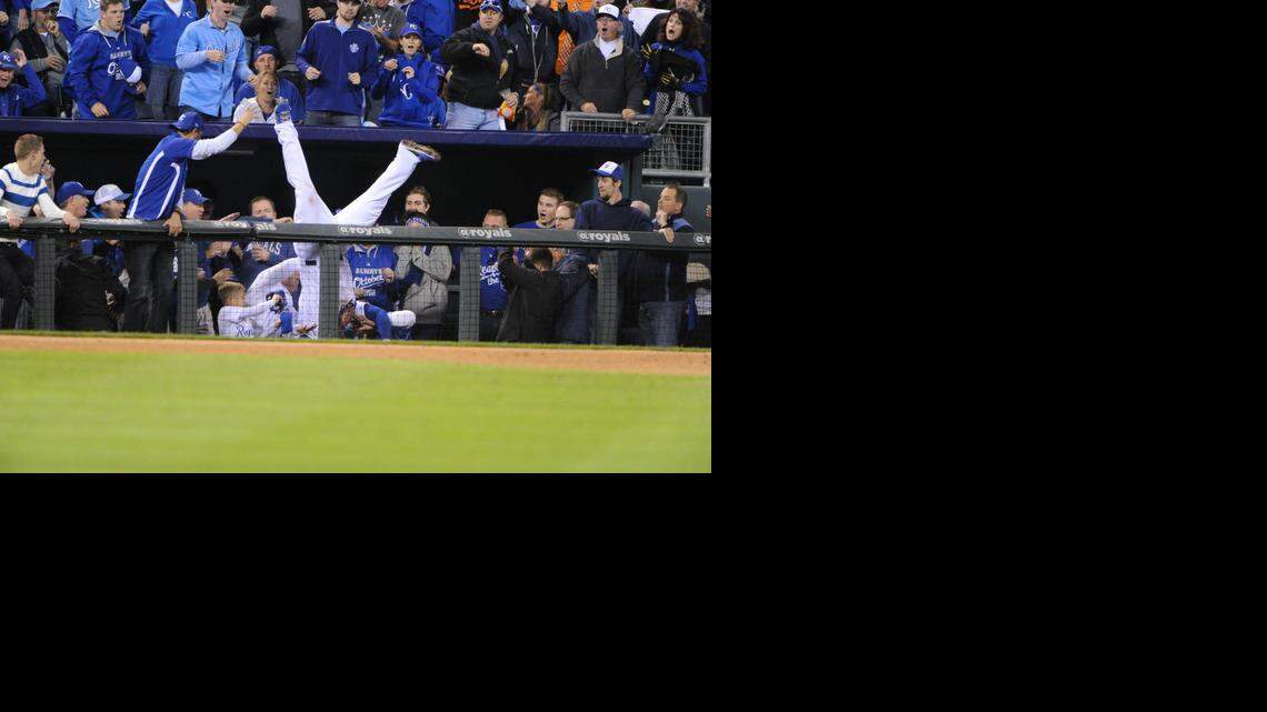 Kansas City Royals third baseman Mike Moustakas dives into dugout suites to catch a foul fly ball by the Baltimore Orioles' Adam Jones in the sixth inning in Game 3 of the American League Championship Series at Kauffman Stadium in Kansas City, Mo., on Tuesday, Oct. 14, 2014. The Royals won, 2-1, for a 3-0 series lead. (Kenneth K. Lam/Baltimore Sun/MCT)
