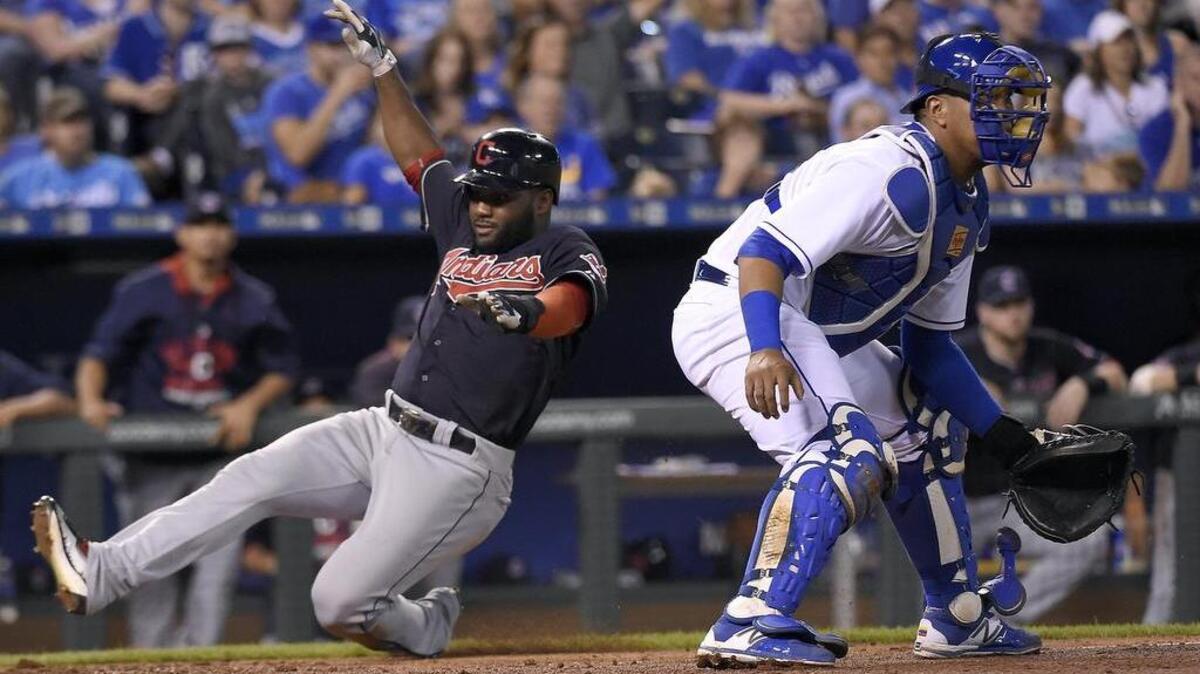 
Cleveland’s Abraham Almonte (35) scores behind Kansas City catcher Salvador Perez on a single by Jason Kipnis in the sixth inning Satuday at Kauffman Stadium in Kansas City, Mo.
