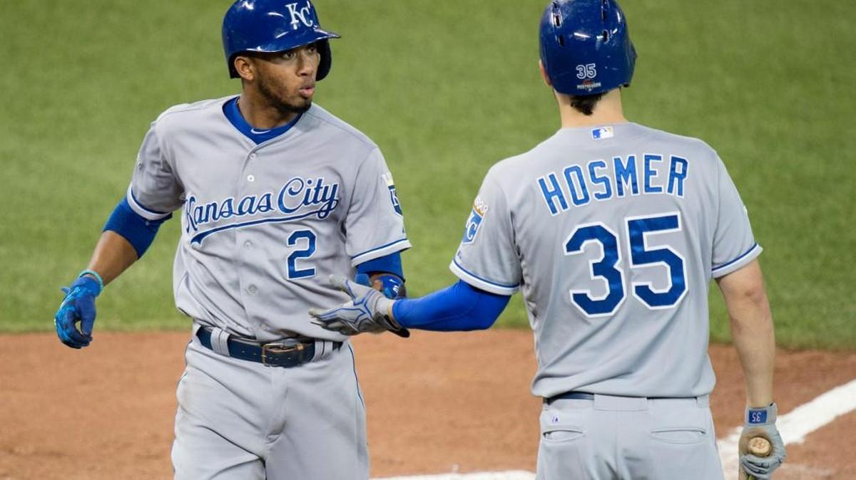 Kansas City’s Alcides Escobar, left, celebrates with teammate Eric Hosmer after scoring on a wild pitch in Tuesday’s fifth inning.