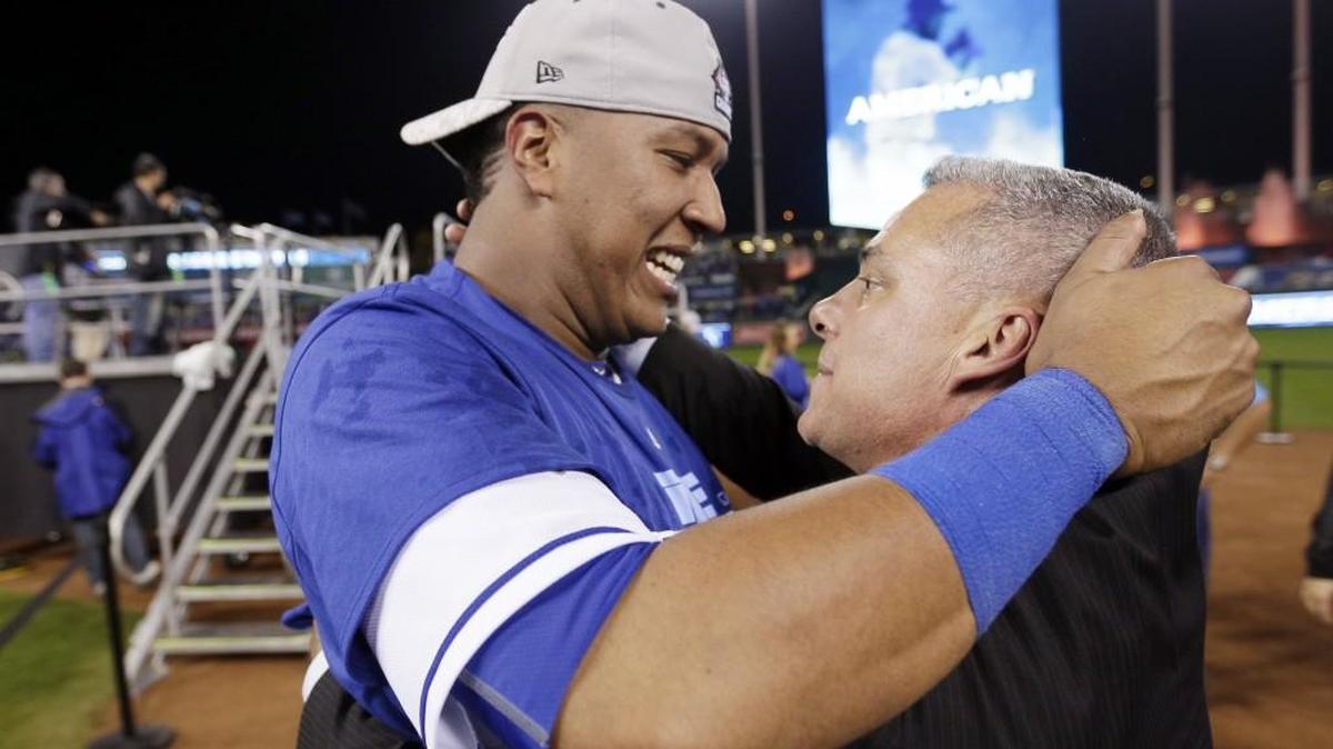 Royals catcher Salvador Perez and GM Dayton Moore celebrate winning the ALCS on Oct. 23, 2015, in Kansas City, Mo.