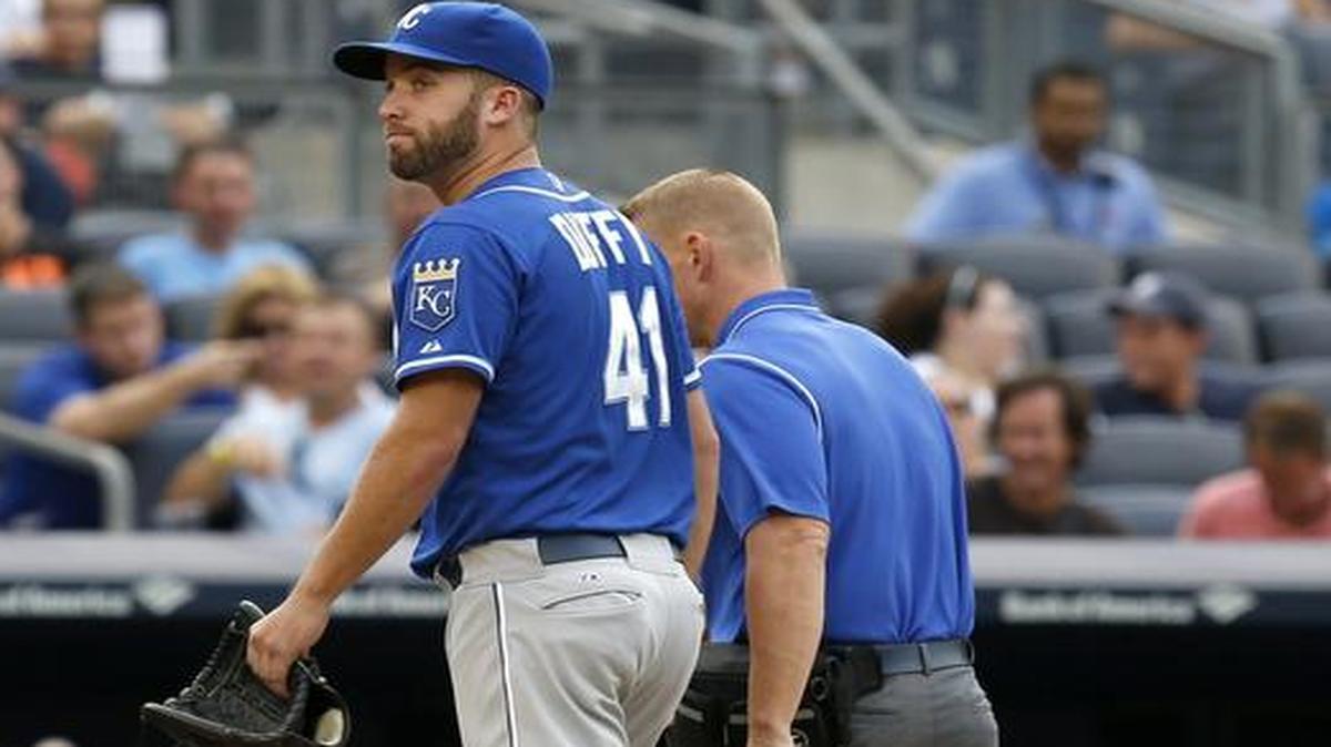 
Royals starting pitcher Danny Duffy leaves the field with trainer Nick Kenney after only throwing one pitch Saturday against the New York Yankees at Yankee Stadium.
