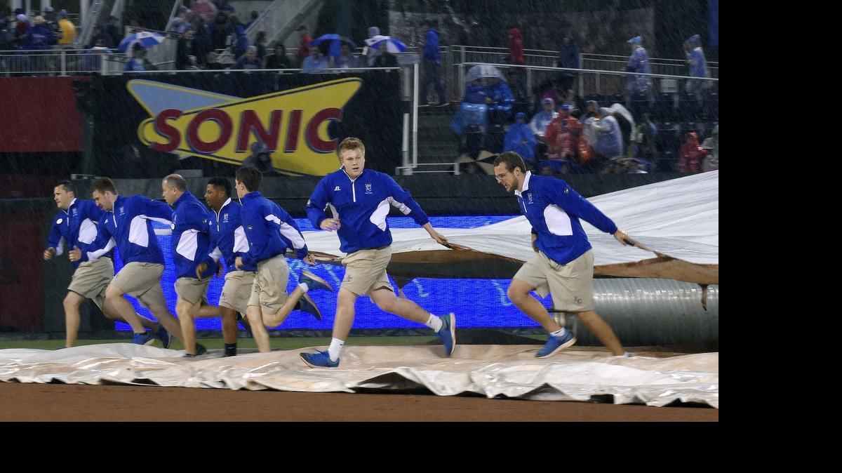
The Kansas City Royals' tarp crew covers the field during a rain delay in the sixth inning against the St. Louis Cardinals on Saturday, May 23, 2015, at Kauffman Stadium in Kansas City, Mo.
