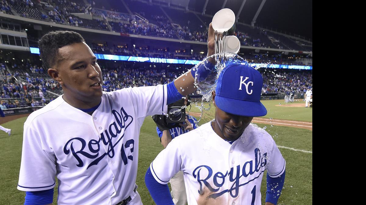 
Kansas City Royals catcher Salvador Perez (13) douses Jarrod Dyson (1) with water after the teams 9-7 win over the Tampa Bay Rays during Wednesday's baseball game on July 8, 2015 at Kauffman Stadium in Kansas City, Mo. Dyson had one of two in the park home runs during the game, Tampa Bay Rays' Logan Forsythe had the other.
