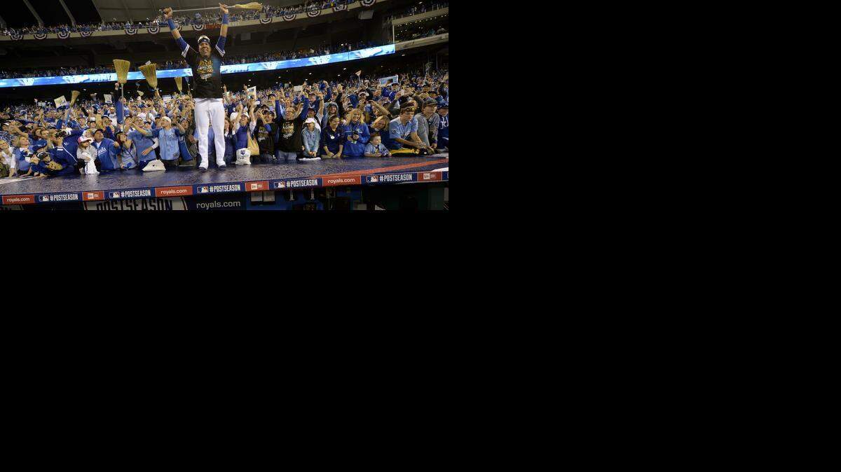 
Standing on the dugout Kansas City Royals catcher Salvador Perez (13) lifts a broom over his head as the team celebrated their ALDS sweep during Sunday's baseball game on October 5, 2014 at Angels Stadium at Kauffman Stadium.
