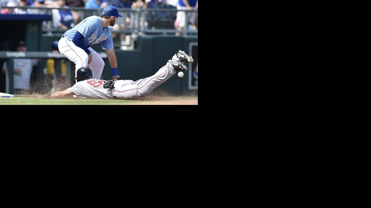 
Boston’s Mookie Betts advances to third as the throw to Kansas City’s Mike Moustakas, left, arrives late in the sixth inning in Kansas City, Mo. 
