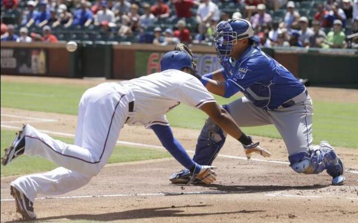 
Royals catcher Salvador Perez right takes a throw as the Rangers' Elvis Andrus dives for home plate during the first inning Sunday in Arlington, Texas. Andrus was tagged out on the play. 
