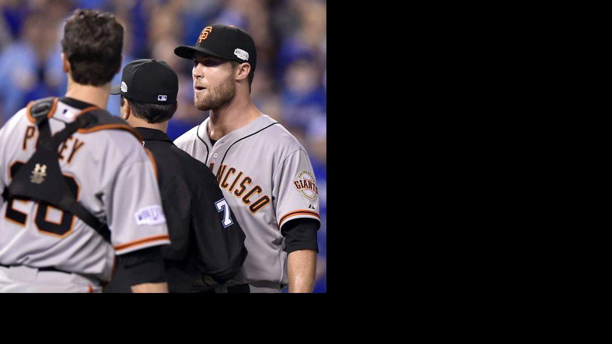 
San Francisco Giants relief pitcher Hunter Strickland is held back by first base umpire Jim Reynolds and teammates San Francisco Giants catcher Buster Posey while Strickland taunted Kansas City Royals catcher Salvador Perez and Kansas City Royals second baseman Omar Infante
