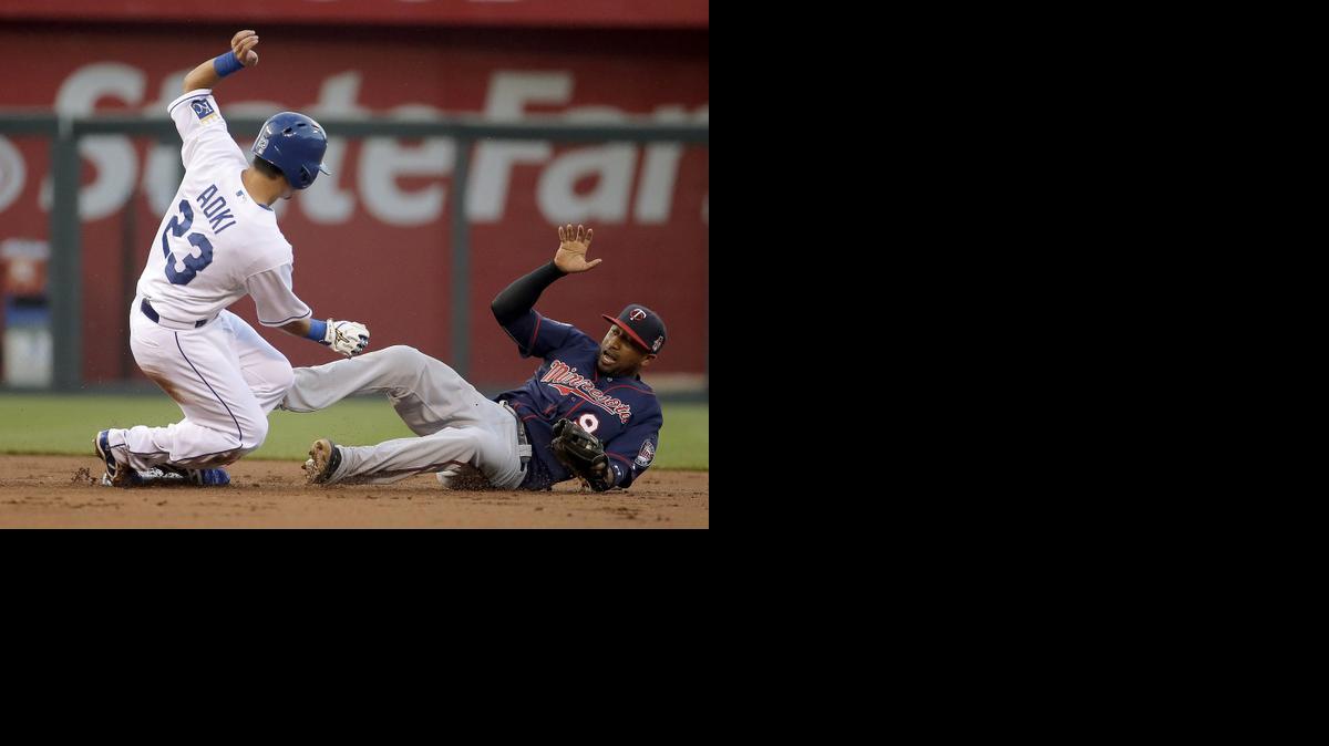 
The Royals’ Norichika Aoki is forced out at second by Twins shortstop Eduardo Nunez in the first inning Thursday at Kauffman Stadium.
