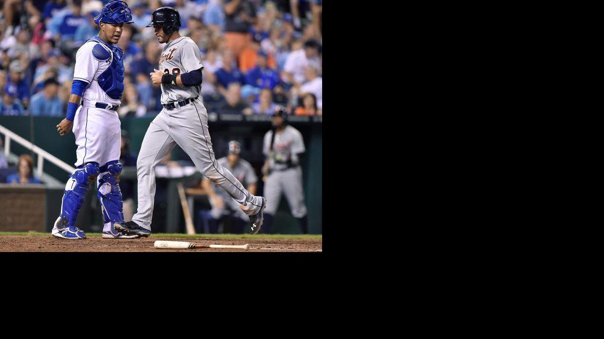 
The Tigers' J.D. Martinez scores past Royals catcher Salvador Perez in the fifth inning during Friday's baseball game at Kauffman Stadium.
