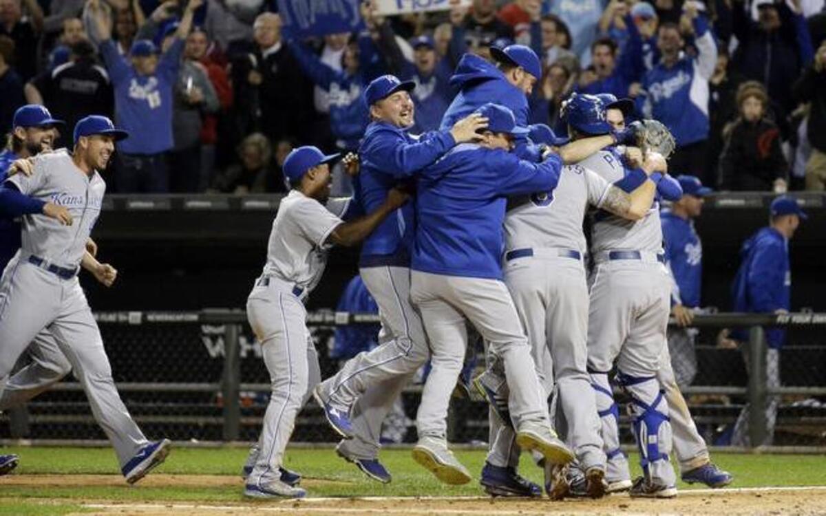 
Kansas City Royals players and coaches celebrate after the Royals defeated the Chicago White Sox 3-1 on Friday in Chicago, locking up a playoff berth.
