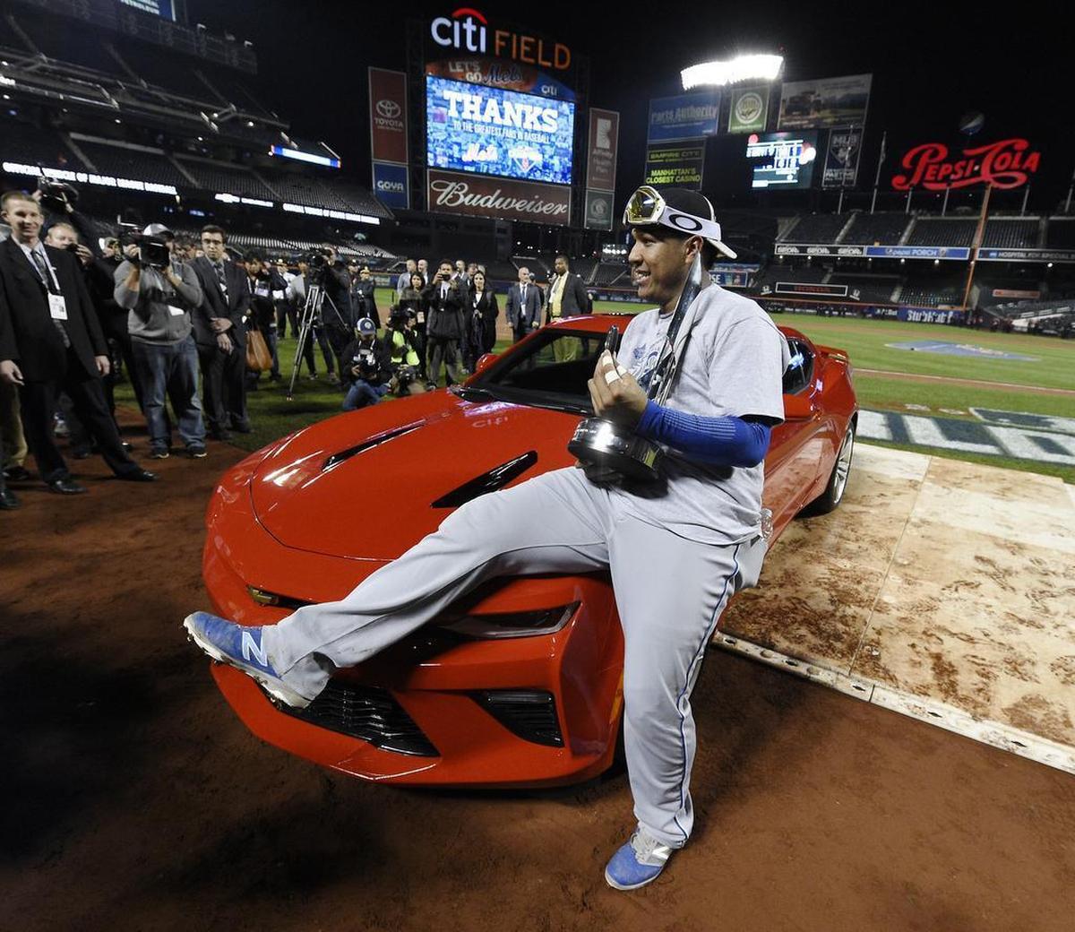 Kansas City Royals catcher Salvador Perez posed with the MVP trophy and the car he was awarded after being named the World Series MVP after game five of the World Series on Sunday, November 1, 2015 at Citi Field in New York.