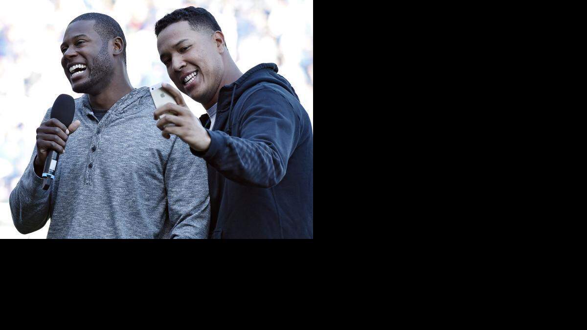 
Royals catcher Salvador Perez takes a selfie with his phone as Lorenzo Cain tries to address the crowd during Thursday’s celebration at Kauffman Stadium in Kansas City, Mo. 
