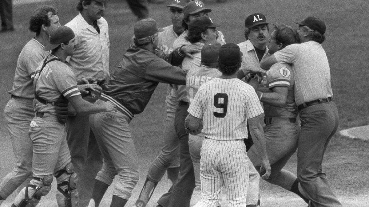 Kansas City Royals third baseman George Brett is restrained by teammates and umpires after the infamous “Pine Tar Game” in 1983 in New York.