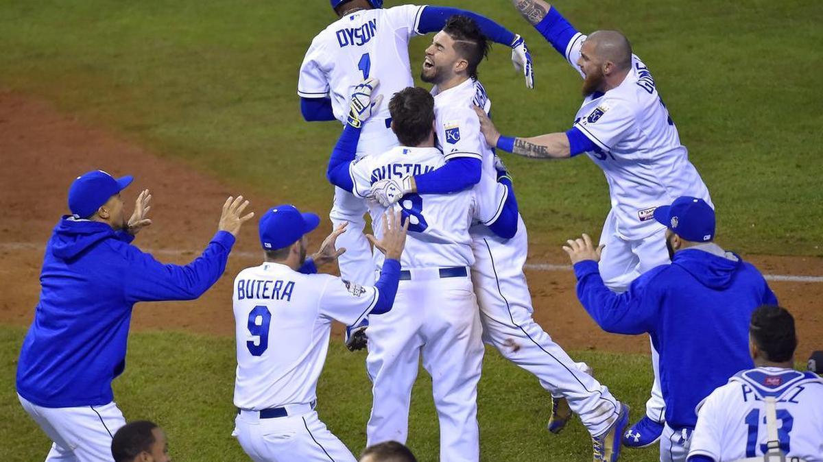 Teammates mobbed Kansas City Royals first baseman Eric Hosmer after he hit a sacrifice fly to score shortstop Alcides Escobar in the fourteenth inning to defeat the New York Mets 5-4 in game one of the World Series on Tuesday, October 27, 2015 at Kauffman Stadium in Kansas City, Mo.