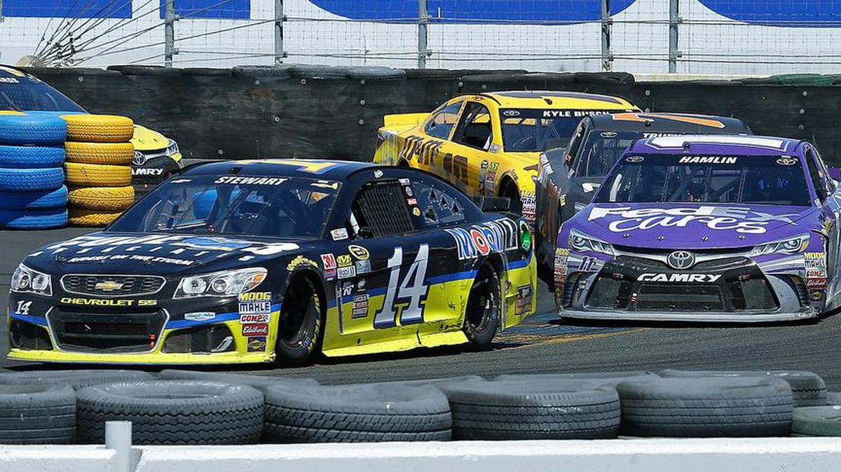 Tony Stewart, left, leads Denny Hamlin through Turn 11 during the NASCAR Sprint Cup Series race Sunday in Sonoma, Calif.