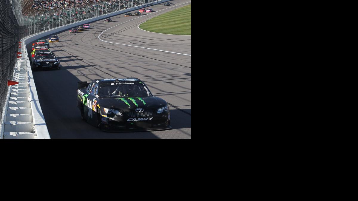 
Kyle Busch leads a line of cars through turn one during the Kansas Lottery 300 race at Kansas Speedway on Saturday in Kansas City, Kan. Busch won the race. 
