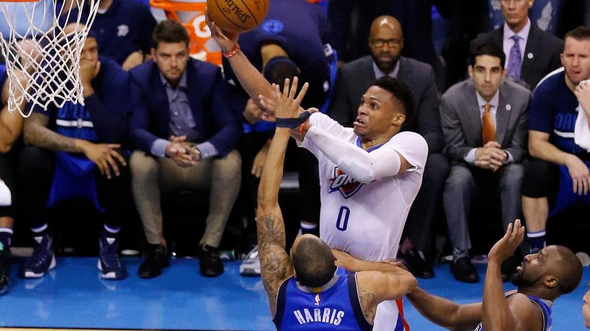 Oklahoma City Thunder guard Russell Westbrook (0) goes up for a basket ahead of Dallas Mavericks guards Devin Harris (34) and Raymond Felton (2) during the second half of Game 5 of their first round NBA playoff series on Monday in Oklahoma City. Westbrook had 36 points, 12 rebounds and nine assists, and the Thunder won 118-104 to capture the series 4-1 and advance to the Western Conference semifinals against San Antonio. Story on 3B.