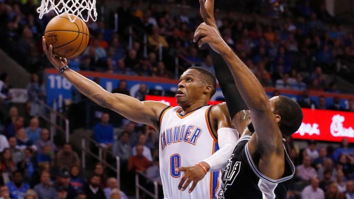 Oklahoma City Thunder guard Russell Westbrook (0) shoots in front of San Antonio Spurs forward LaMarcus Aldridge, right, in the first quarter on Wednesday night in Oklahoma City.