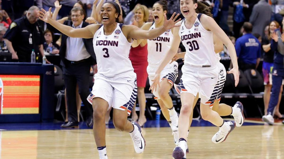 Connecticut’s Morgan Tuck (3), Kia Nurse (11) and Breanna Stewart (30) celebrate after their 82-51 victory over Syracuse in the championship game at the women’s Final Four on Tuesday in Indianapolis.