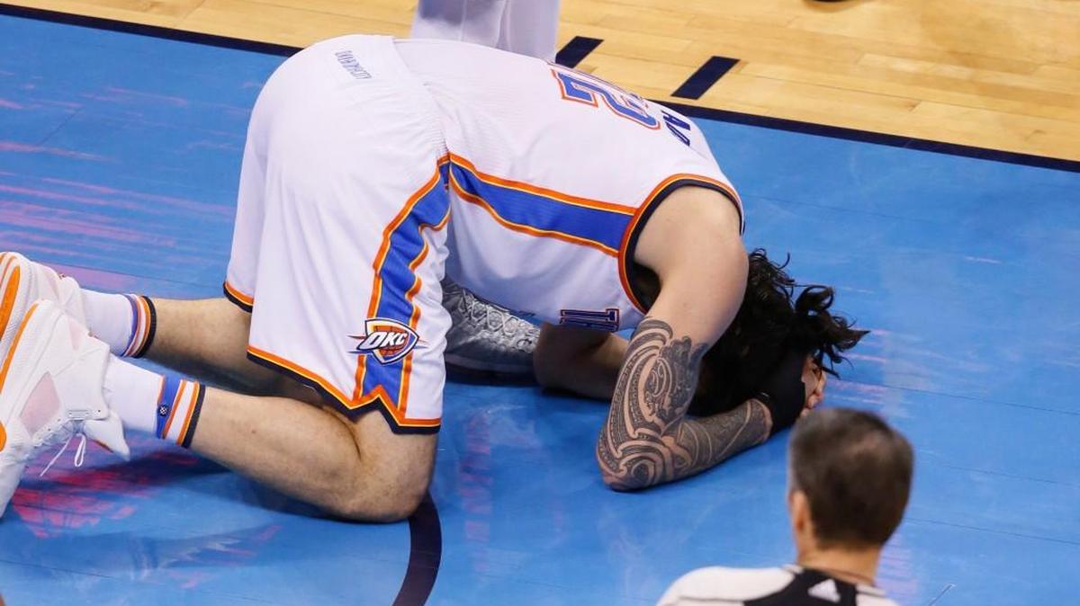 Thunder center Steven Adams lies on the floor after being fouled by Warriors forward Draymond Green in the first half of Game 3 on Sunday.