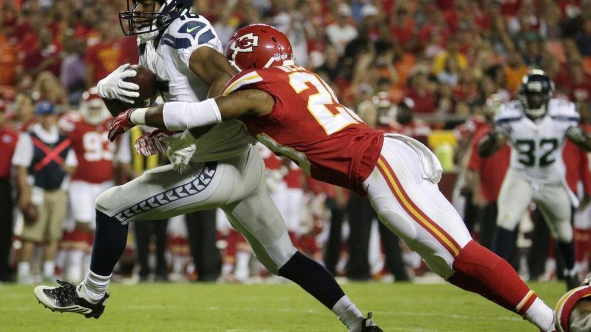 
Seattle Seahawks wide receiver Tyler Lockett (16) is tackled by Kansas City Chiefs cornerback Steven Nelson (20) during the second half of a preseason NFL football game at Arrowhead Stadium in Kansas City, Mo., on Friday. (Aug. 21, 2015)

