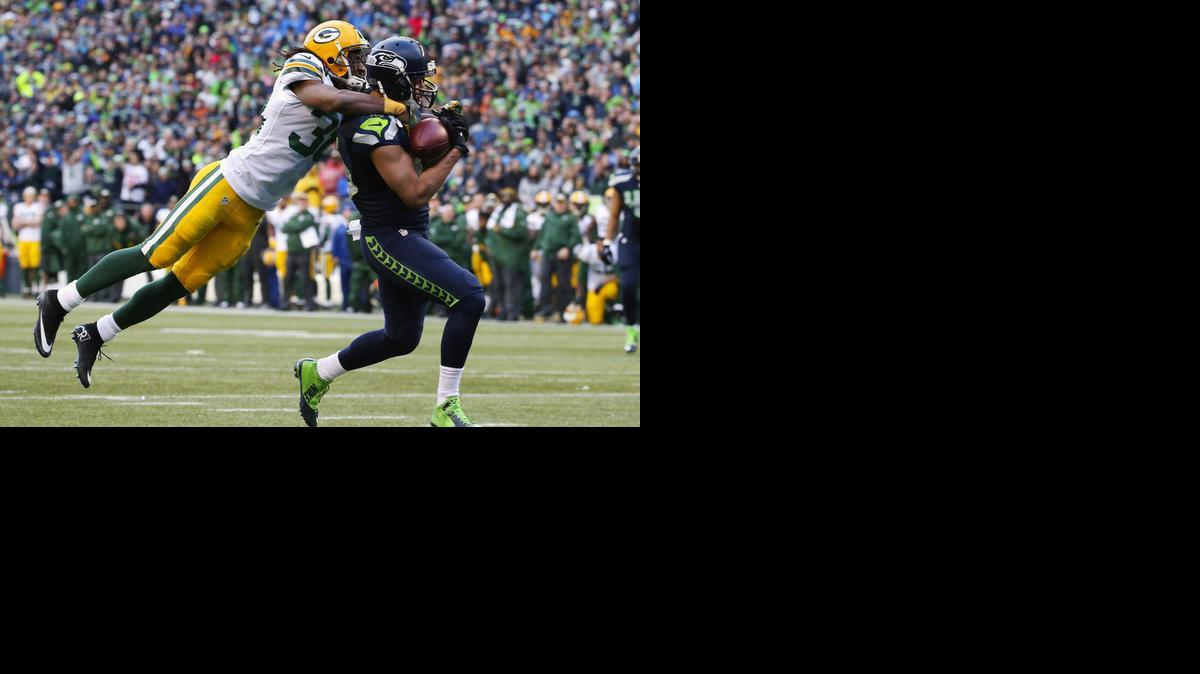 
Seattle wide receiver Jermaine Kearse, right, pulls in the game-winning touchdown with Green Bay cornerback Tramon Williams on his back during overtime Sunday in Seattle. 
