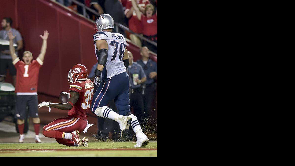 
Kansas City Chiefs free safety Husain Abdullah (39) returned an interception for a touchdown ahead of New England Patriots tackle Sebastian Vollmer (76) during the NFL game on Monday, Sept. 29, at Arrowhead Stadium in Kansas City. The Chiefs won 41-14.
