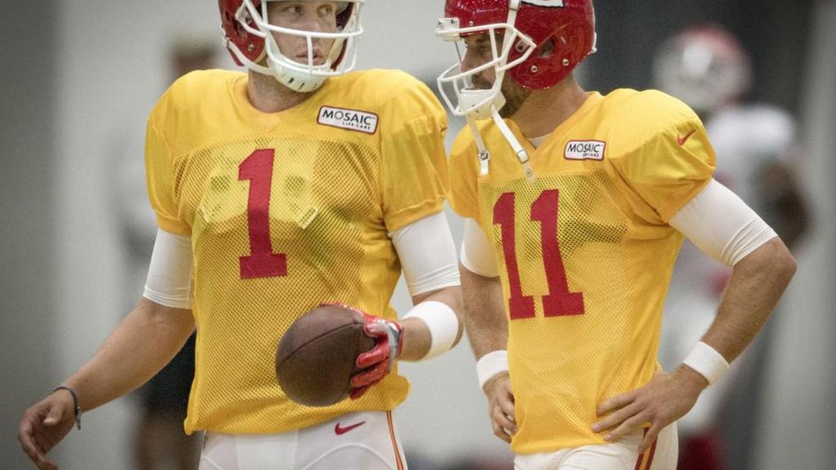 New Chiefs quarterback Nick Foles stands with Alex Smith (11) as they wait their turns to run a drill during Foles’ first practice as a Chief on Friday in St. Joseph, Mo.