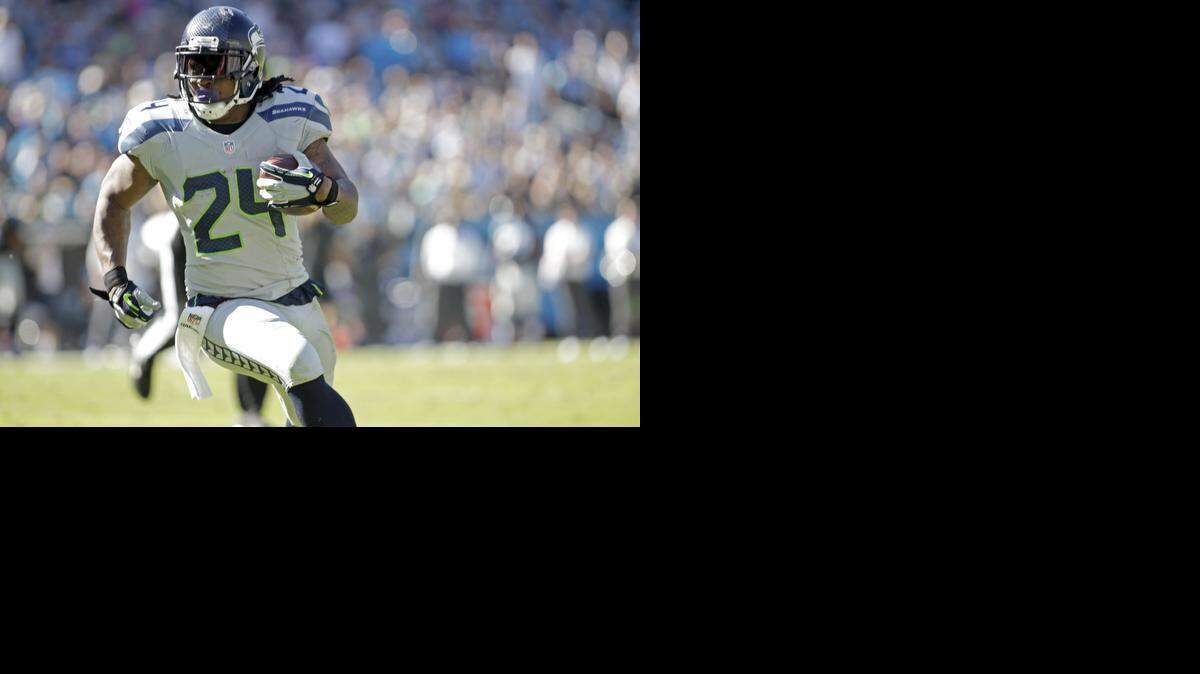
Seattle’s Marshawn Lynch runs the football against the Carolina Panthers during the second half of an NFL football game Sunday, Oct. 26, 2014, in Charlotte, N.C. The Seahawks won 13-9. (AP Photo/Bob Leverone)
