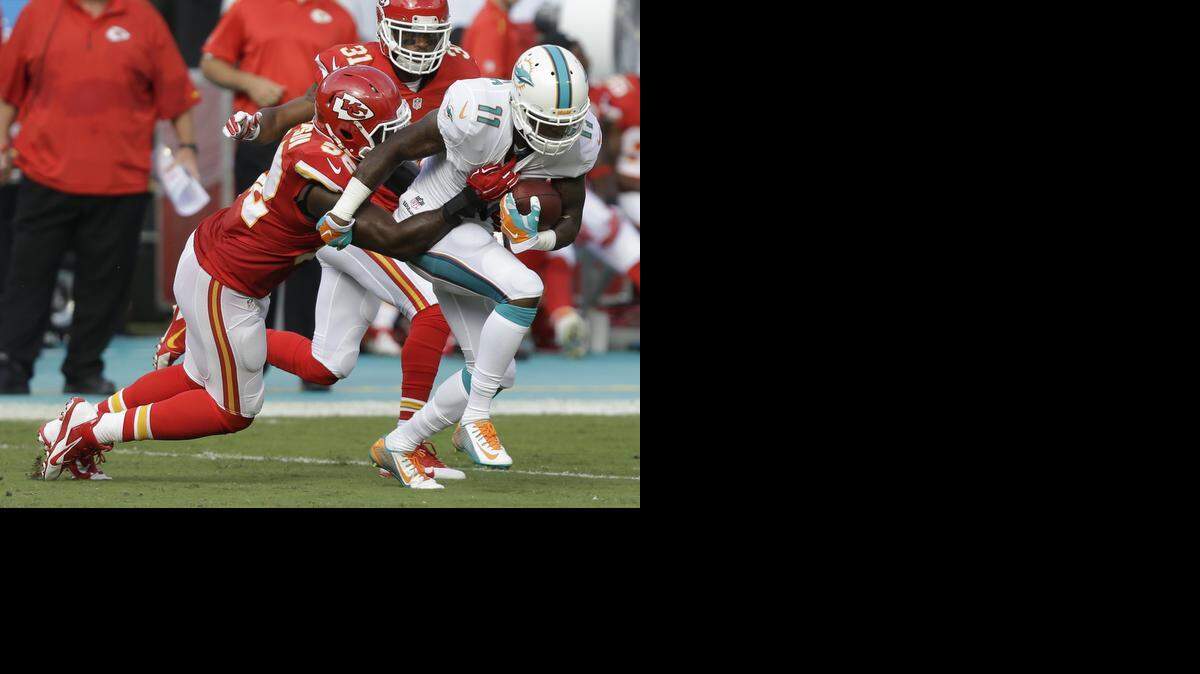 
Kansas City Chiefs inside linebacker James-Michael Johnson tackles Miami receiver Mike Wallace in Sunday’s game.
