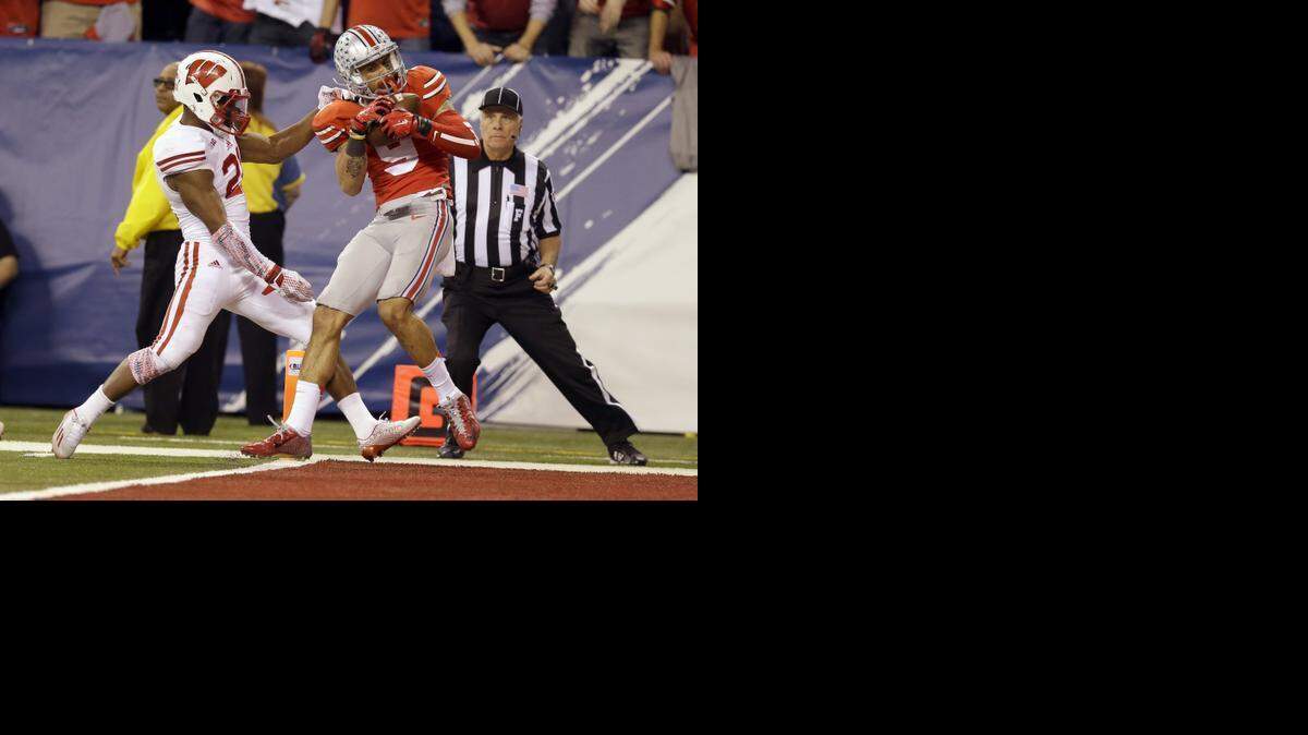 
Ohio State wide receiver Devin Smith (right) caught a 42-yard pass for a touchdown against Wisconsin cornerback Peniel Jean in the Big Ten Conference Championship Game.
