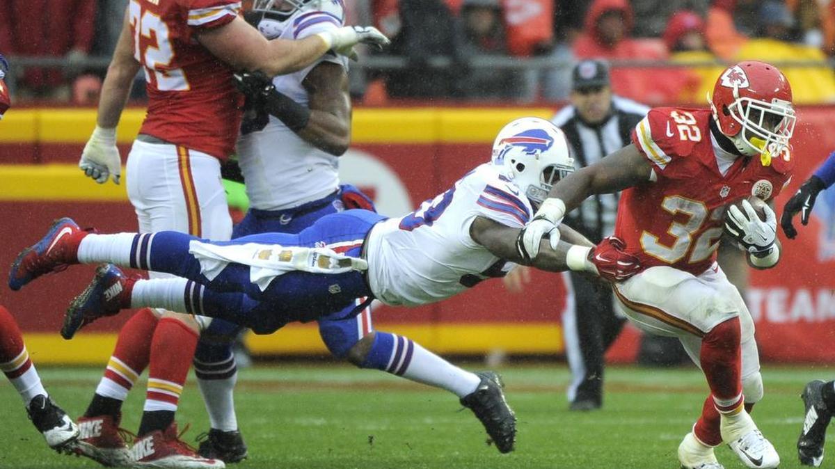 Kansas City Chiefs running back Spencer Ware (32) runs past a tackle-attempt by Buffalo Bills linebacker Nigel Bradham (53) during the first half of an NFL football game in Kansas City, Mo., on Sunday.