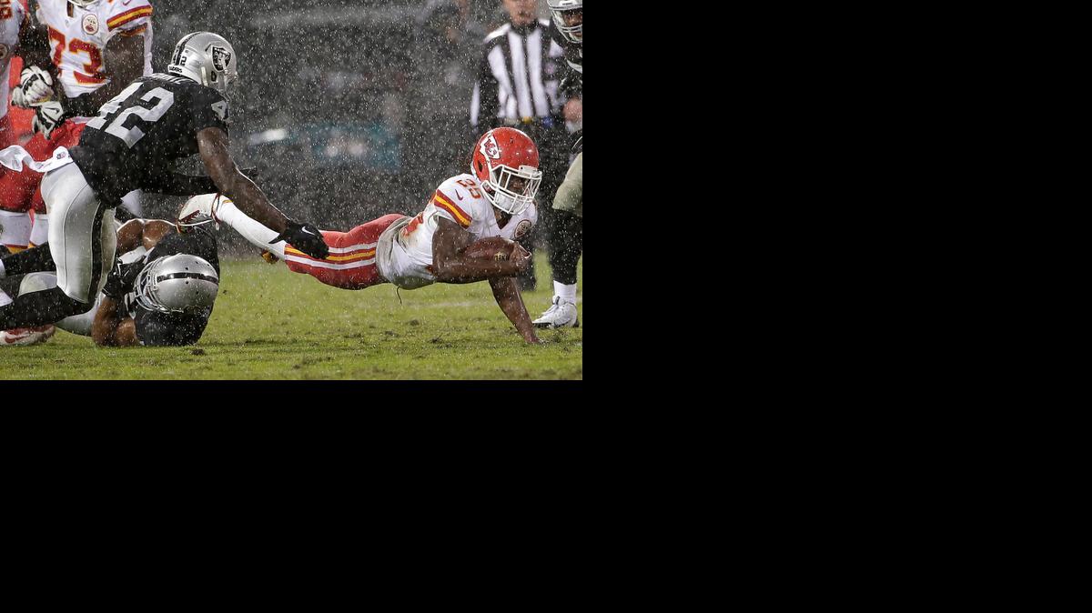 
Kansas City Chiefs running back Jamaal Charles falls forward after being tackled by Oakland Raiders outside linebacker Khalil Mack and defensive back Larry Asante (42) during the second quarter Thursday in Oakland, Calif.
