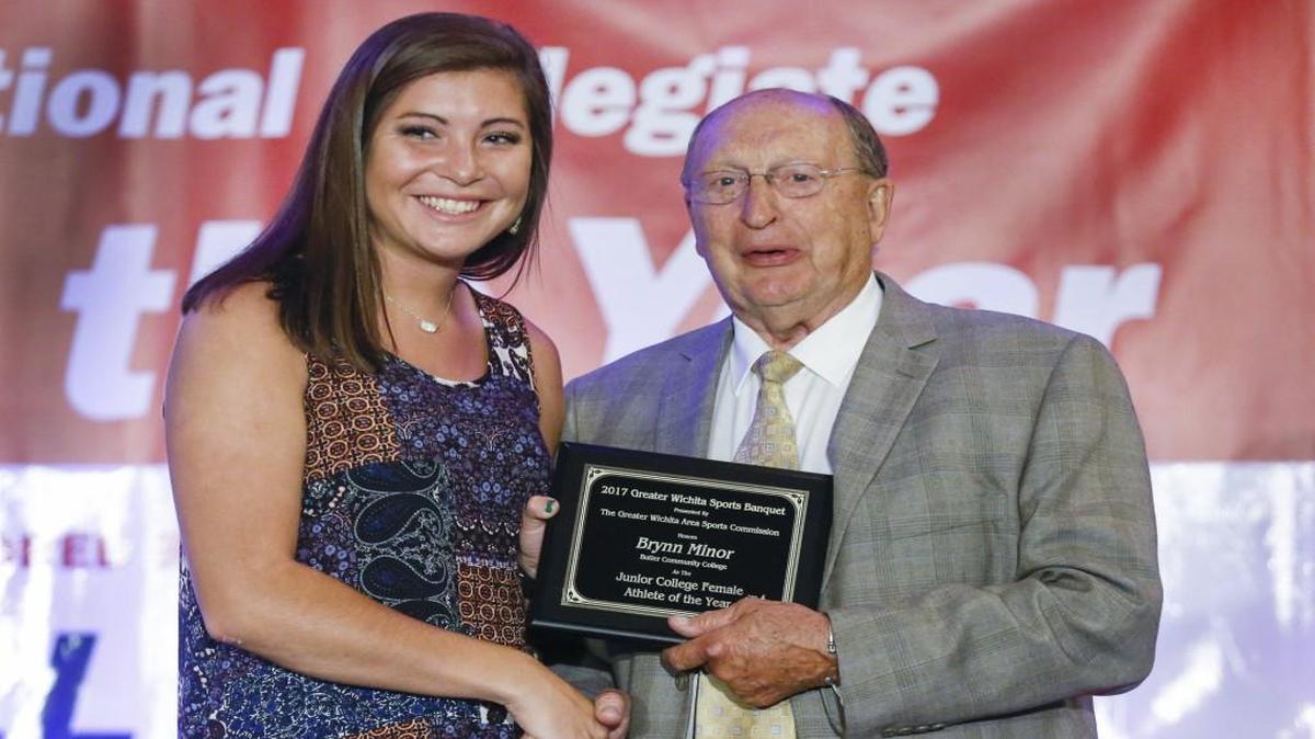 Butler Community College softball player Brynn Minor accepts the award for Junior College Female Athlete of the Year from Greater Wichita Sports Commission President Bob Hanson at the 20th Greater Wichita Sports Banquet on Thursday at the Hyatt.