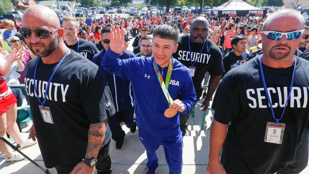 Surrounded by security, Nico Hernandez makes his way into North High after a parade in his honor on Saturday. Hernandez won a bronze medal in boxing at the Olympics in Rio earlier this month.